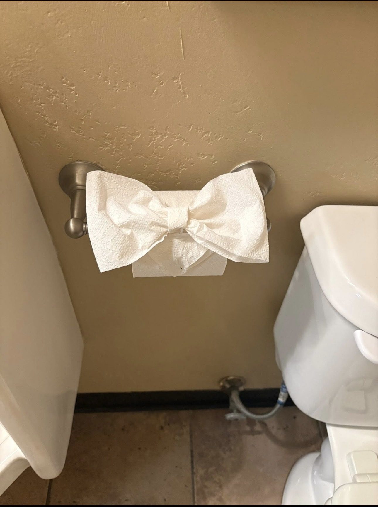 Toilet paper folded into a bow