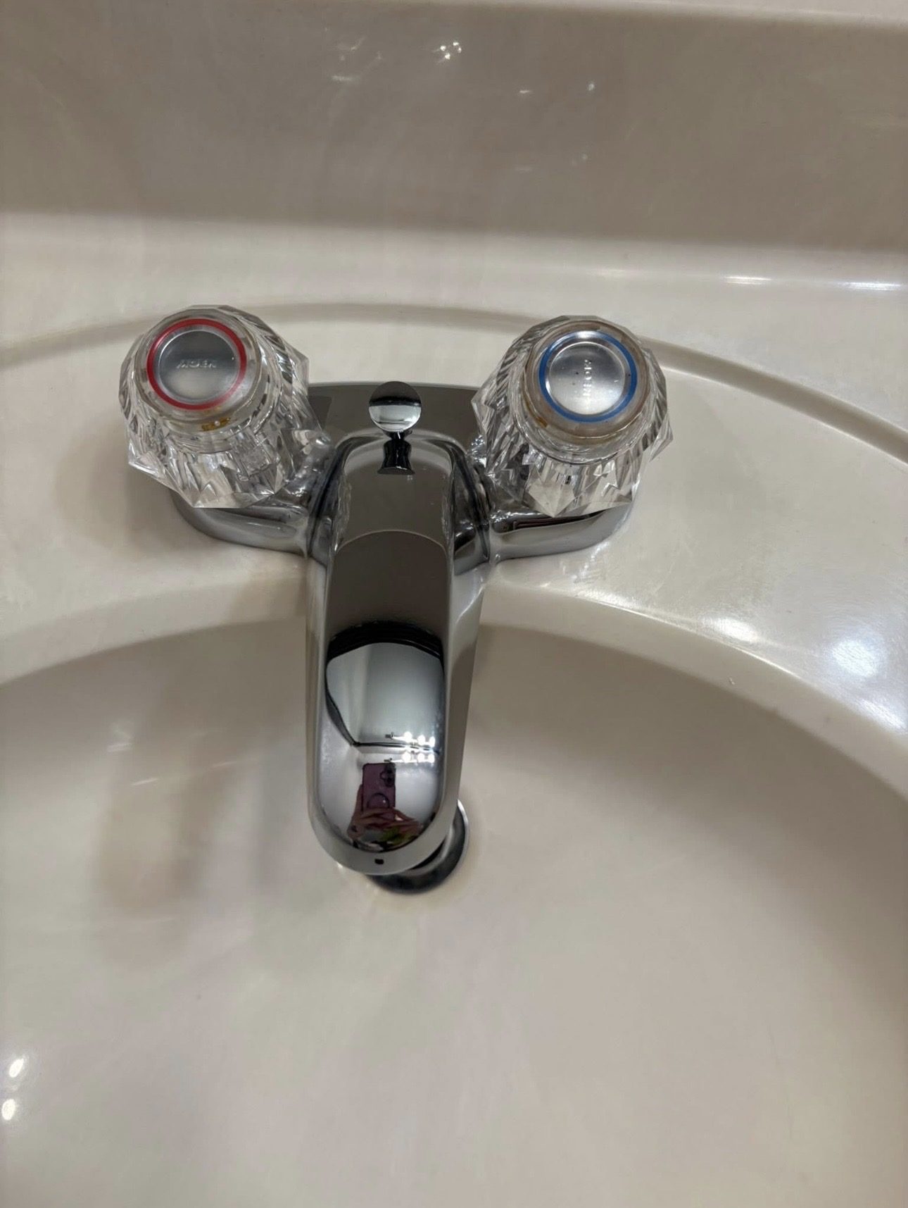 Bathroom faucet after cleaning, polished chrome