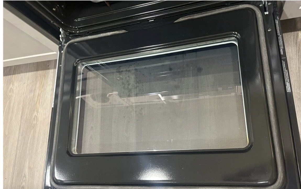 Oven door glass before cleaning
