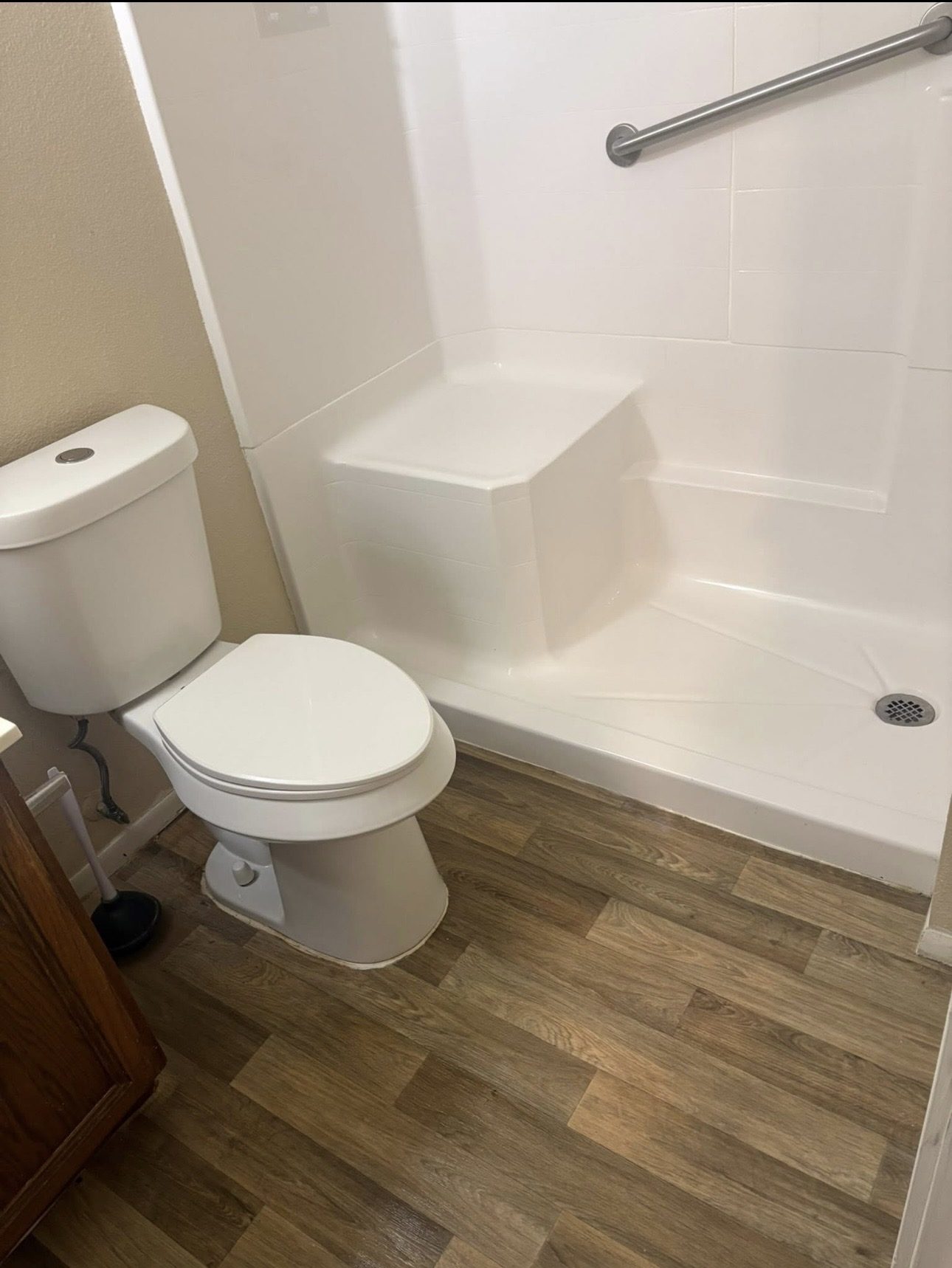 Accessible shower before cleaning, grime on the floor