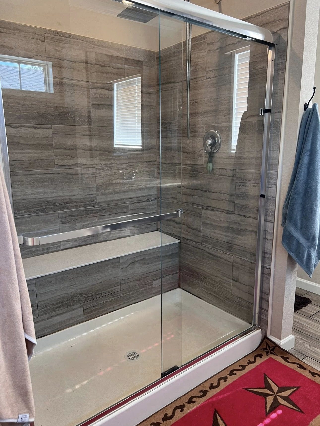 Glass shower enclosure after cleaning, clear glass and floor