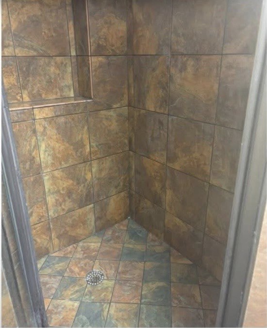Stone tile shower after cleaning, tiles restored