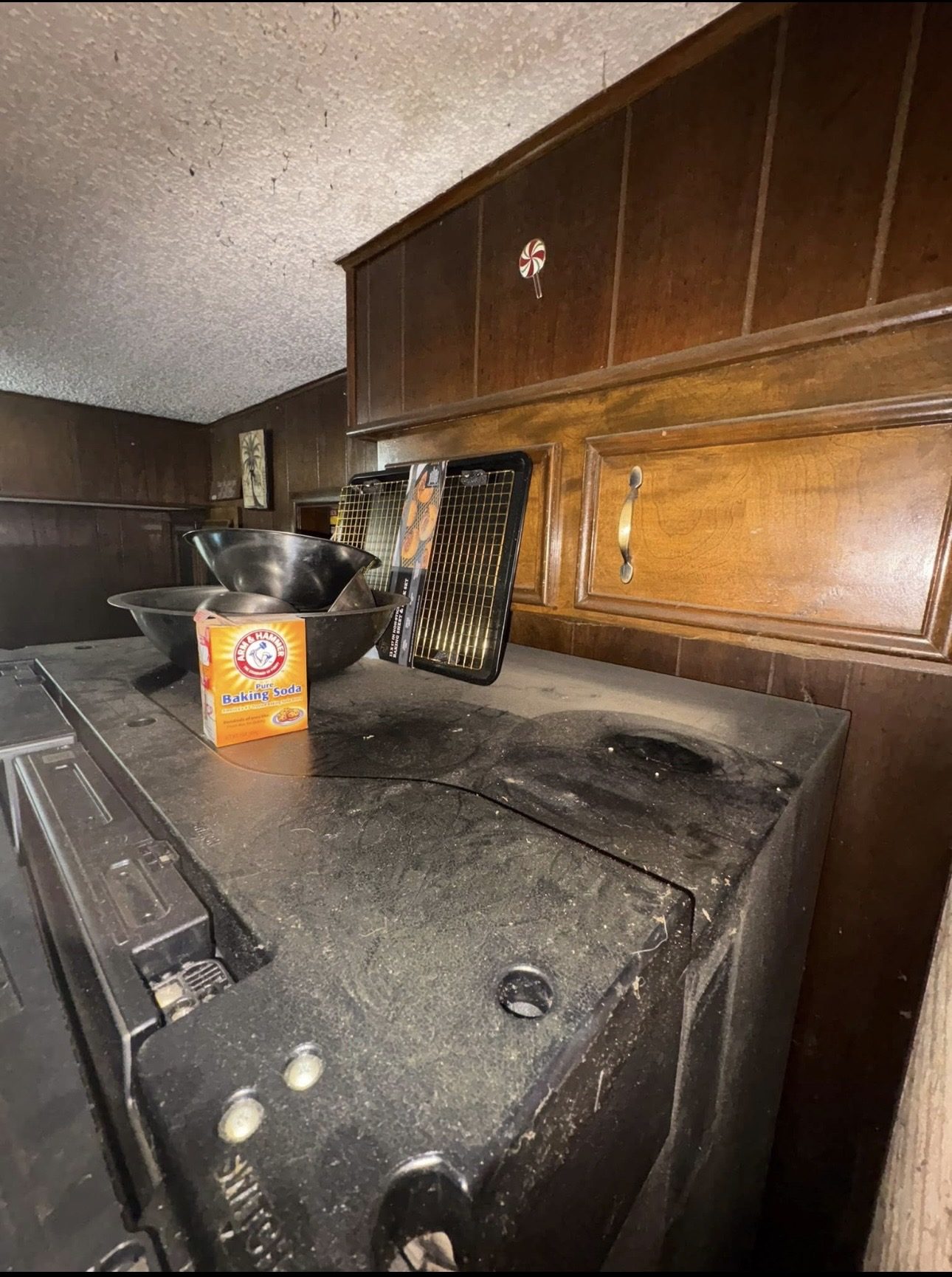 Kitchen before deep cleaning, dusty stovetop and counter